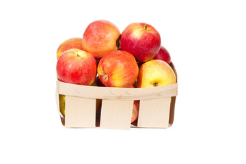 Fresh red apples in wooden basket isolated, autumn harvest
