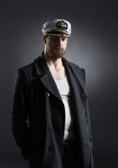 Portrait of a handsome sailor on a dark background