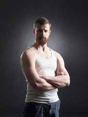 Strong, handsome and bearded man on black