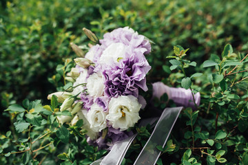 beautiful bridal bouquet of blue flowers on a green background