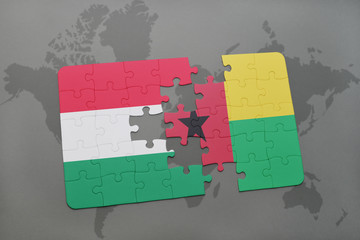 puzzle with the national flag of hungary and guinea bissau on a world map