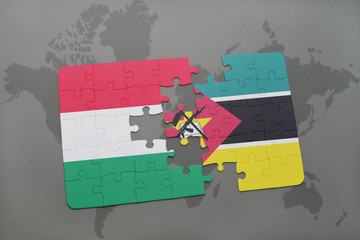 puzzle with the national flag of hungary and mozambique on a world map