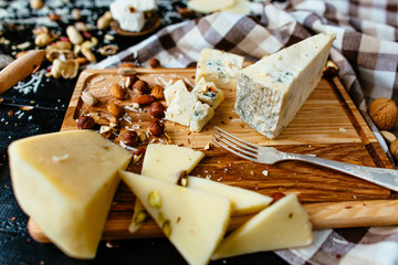 Cheeseboard. Assortment of  Delicious cheese on the board. Cheese with nuts