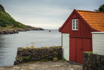 Boat with red sail on a calm sea