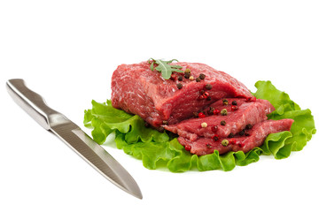 Meat with a knife and spices on white background