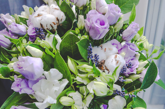 Rich bunch of violet spring garden flowers. Eustoma roses, green leaf. Fresh summer bouquet on nature background. Copy space