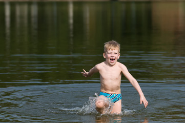 Six years old boy going out the lake