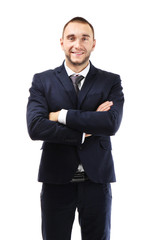Young business coach with crossed hands standing on white background