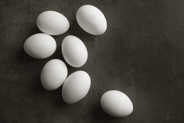 Raw eggs on color background