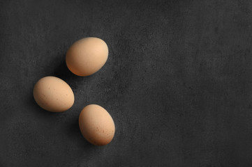 Raw eggs on color background