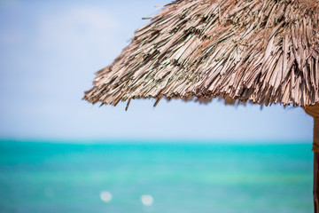 Fototapeta na wymiar Closeup straw beach umbrella on tropics
