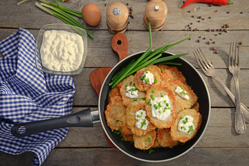 Composition with tasty potato pancakes for Hanukkah on wooden table