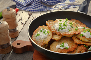 Composition with tasty potato pancakes for Hanukkah on wooden table, closeup