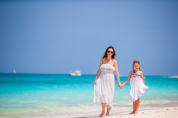 Mother and little daughter enjoying time at tropical beach
