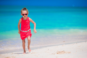 Cute little girl at beach during tropical vacation