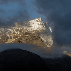 Look through clouds on Nupla peak from a track near the capital sharpa Namche Bazar - Nepal,...