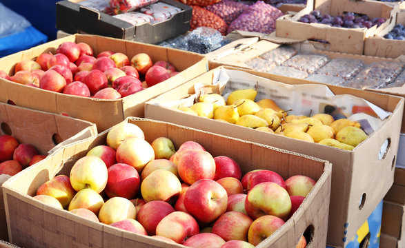 Fresh fruits in cardboard boxes on market