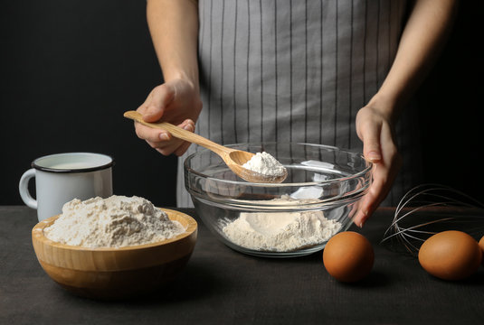 Woman making dough on kitchen table