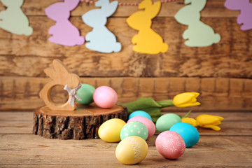 Easter eggs and decorations on wooden background