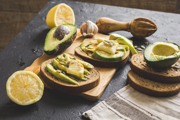 making sandwiches with avocado healthy organic food top view