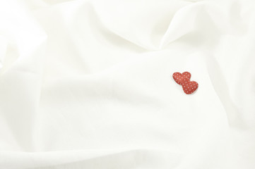 valentines day background with two hearts on linen fabric backgr