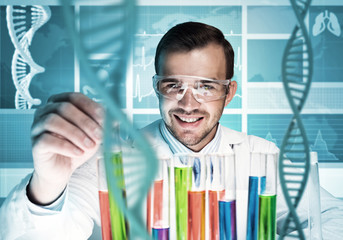 Young scientist mixing reagents in glass flask in clinical laboratory