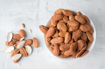 Almond nuts snack in a ceramic bowl. Top view