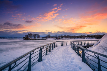View of a frozen lake during sunrise in winter season.
Location: Ramsey Lake, Ontario, Canada