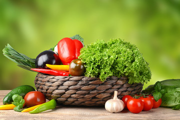 Fresh vegetables on wooden table against blurred background