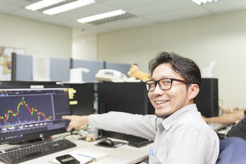 The business man get happy smile and point to the graph of stock