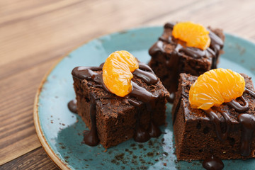 Homemade chocolate brownies with fresh oranges