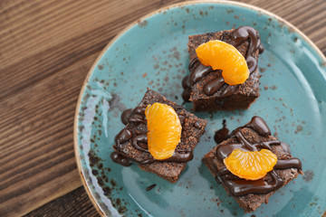 Homemade chocolate brownies with fresh oranges