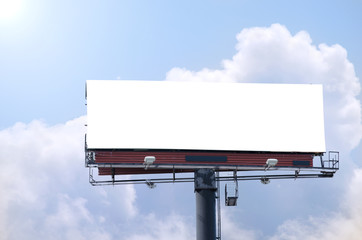 Blank roadside billboard on a bright sunny blue sky day with area for your message, text and photos.