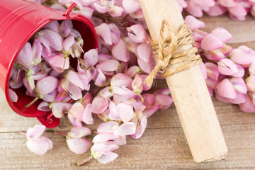 The flowers are lupine and paper scroll on wooden background