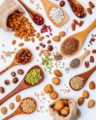 Various legumes and different kinds of nuts in spoons. Walnuts k