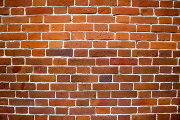 Naklejka premium The red brick wall as background