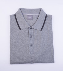 shirt or mens folded polo shirt on background.