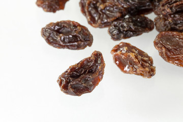 Dried raisins on white background.