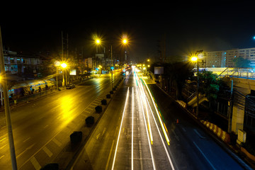 Bangkok at night, light and dark on the road.