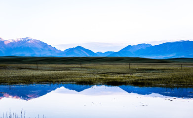 Early morning, mountain and water reflection.