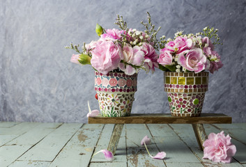 Pink carnation in mosaic flower pot