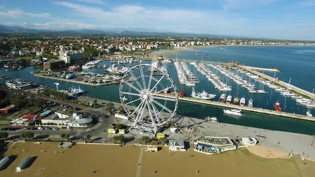 A beautiful Bay to Rimini with a floating yacht and Ferris wheel, aerial view