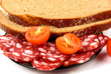 Smoked sausage, cherry tomatoes and bread on a white background