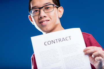 pride Chinese man holding a contract