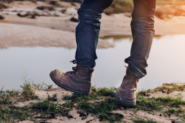 Tourists hiking shoes Standing on the edge of a cliff along the