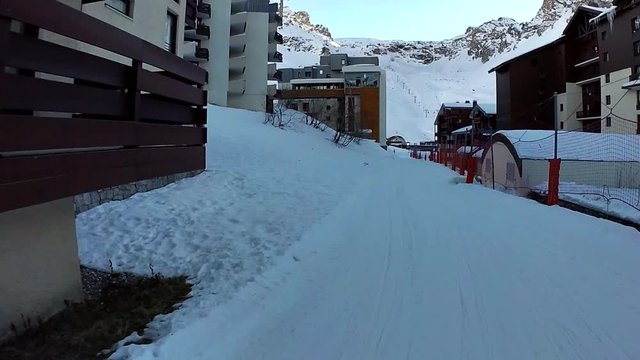 Slow motion: The view on slope for skiing which goes through the town, Tignes, France