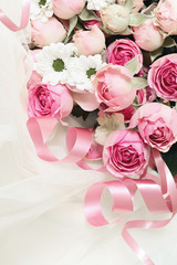 Pink rose flowers and ribbons on veil