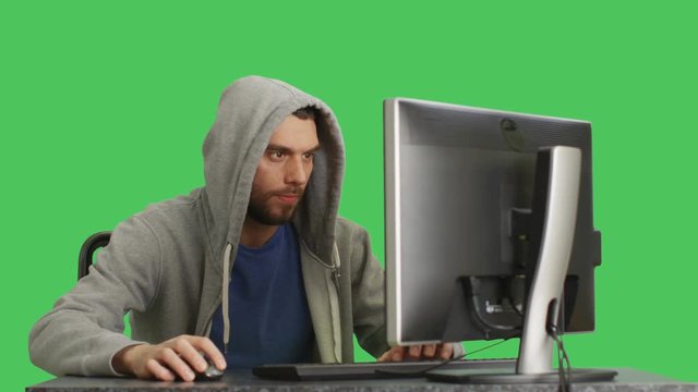Mid Shot of a Gamer Playing Games at His Desktop. Background is green Screen.  Shot on RED Cinema Camera 4K (UHD).