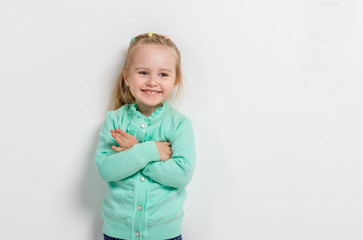 cheerful little girl with her arms folded