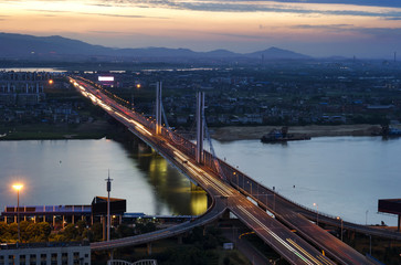 Fototapeta na wymiar City at dusk, aerial view of the bridge.